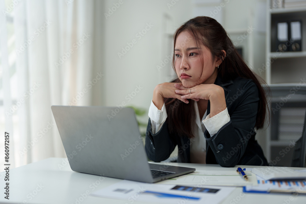 A businesswoman who is tired, stressed, and sore from working for a long time. After waiting for news Unsuccessful business approval results on laptop in office. Startup time concept, office syndrome A businesswoman who is tired, stressed, and sore from working for a long time. After waiting for news Unsuccessful business approval results on laptop in office. Startup time concept, office syndrome
