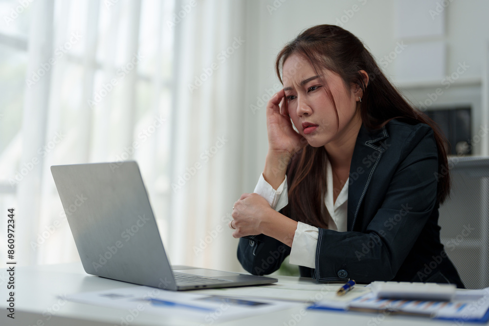 A businesswoman who is tired, stressed, and sore from working for a long time. After waiting for news Unsuccessful business approval results on laptop in office. Startup time concept, office syndrome A businesswoman who is tired, stressed, and sore from working for a long time. After waiting for news Unsuccessful business approval results on laptop in office. Startup time concept, office syndrome