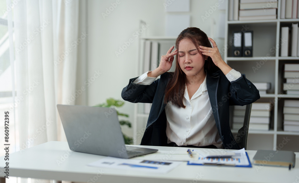 A businesswoman who is tired, stressed, and sore from working for a long time. After waiting for news Unsuccessful business approval results on laptop in office. Startup time concept, office syndrome A businesswoman who is tired, stressed, and sore from working for a long time. After waiting for news Unsuccessful business approval results on laptop in office. Startup time concept, office syndrome