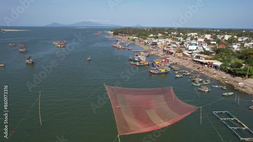 Forward reveal aerial shot of fishing boats near by Duy Hai Fish Market. Vietnam. photo