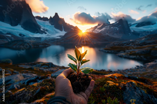 eco earth day concept. hand holding young plant in mountain sunset landscape background . AI Generative photo