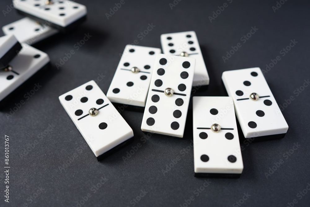 white domino blocks on black background. There are some benefits of playing domingo; helps to develop critical thinking skills, bond with families and social groups, reduces stress, improve memory. white domino blocks on black background. There are some benefits of playing domingo; helps to develop critical thinking skills, bond with families and social groups, reduces stress, improve memory.