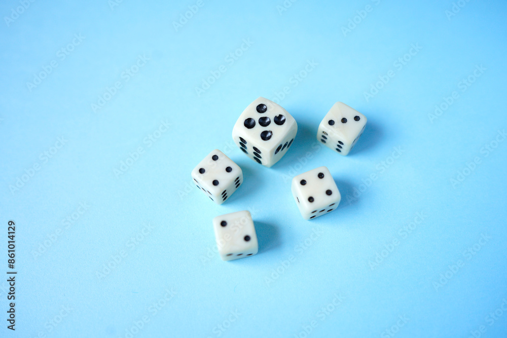 White dices on blue background.The Dice game is one of the oldest of all the games in the world and. It can play by all of ages of player. Top view of dices.
White dices on blue background.The Dice game is one of the oldest of all the games in the world and. It can play by all of ages of player. Top view of dices.