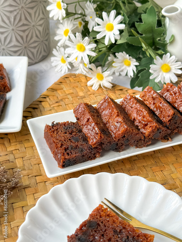 Kek Buah Kukus, a traditional Malaysian steamed fruit cake filled with dried fruits, nuts, and spices, enjoyed during celebrations. photo