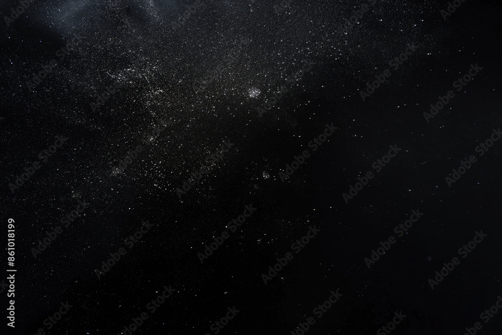 Fototapeta premium White particles floating on a black background