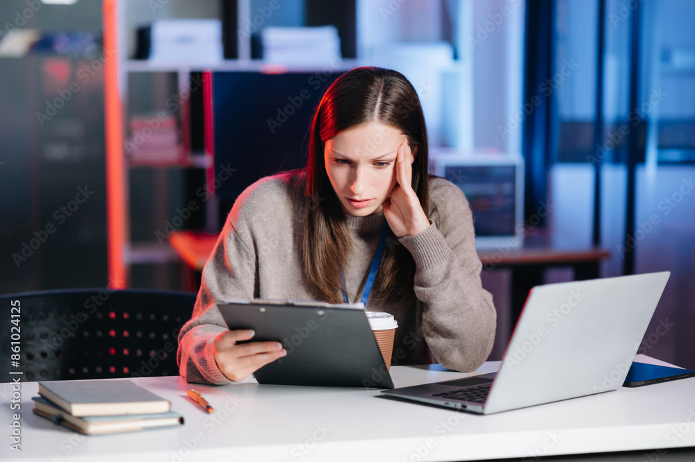 Business woman drinking coffee to get some energy for working overtime sitting at desk using computer and doing overtime project. Business woman drinking coffee to get some energy for working overtime sitting at desk using computer and doing overtime project.