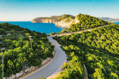 Lighthouse on the cliff. Seascape of Cape Lefkatas with old lighthouse on Lefkada island, Greece. Beautiful views of azure sea water and nature with cliffs photo