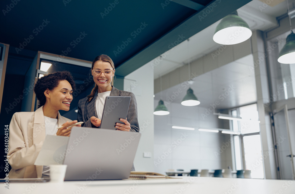 Female boss discussing project with employee showing presentation to team leader Female boss discussing project with employee showing presentation to team leader
