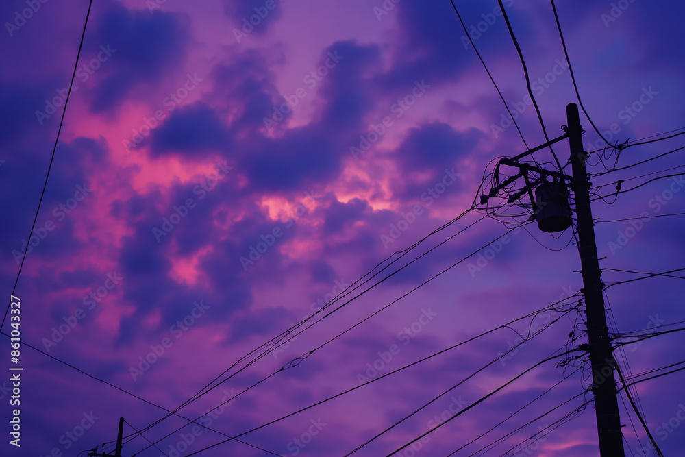 Purple and pink cloudscape with utility pole and wires at sunset Purple and pink cloudscape with utility pole and wires at sunset
