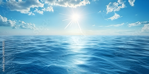 Beautiful view of the sea with the sun shining in a blue sky in the background
