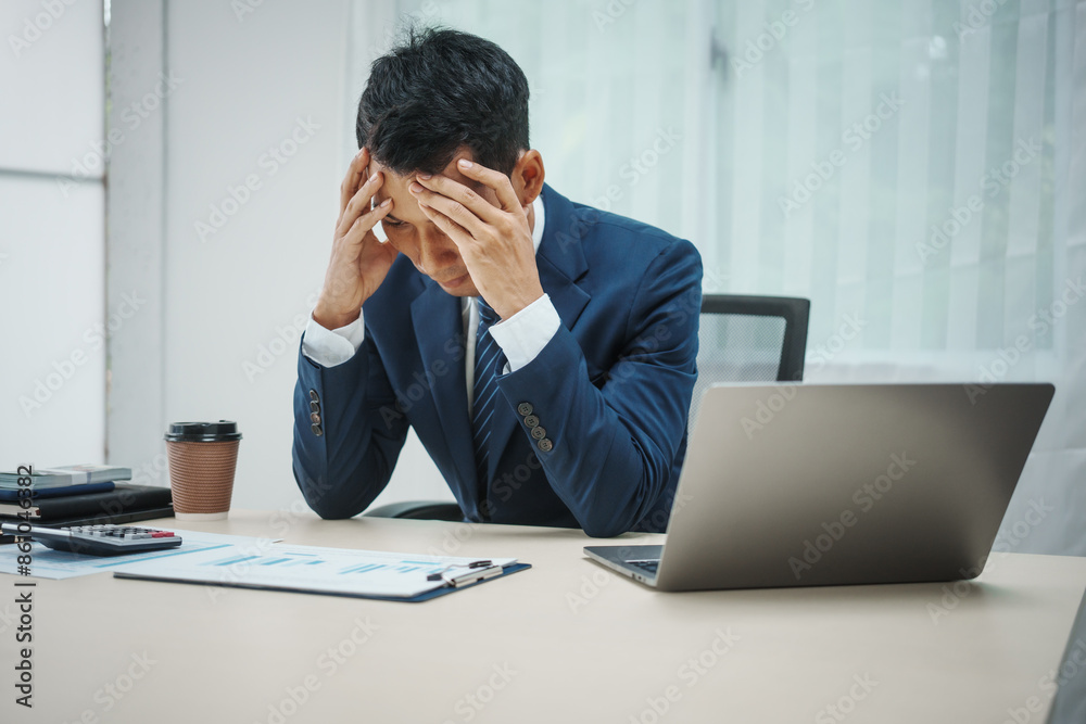A banker in a suit works at a desk, handling loans, analyzing client financial data, providing financial advice, dealing with stocks, and researching economic situations. Economic stress from