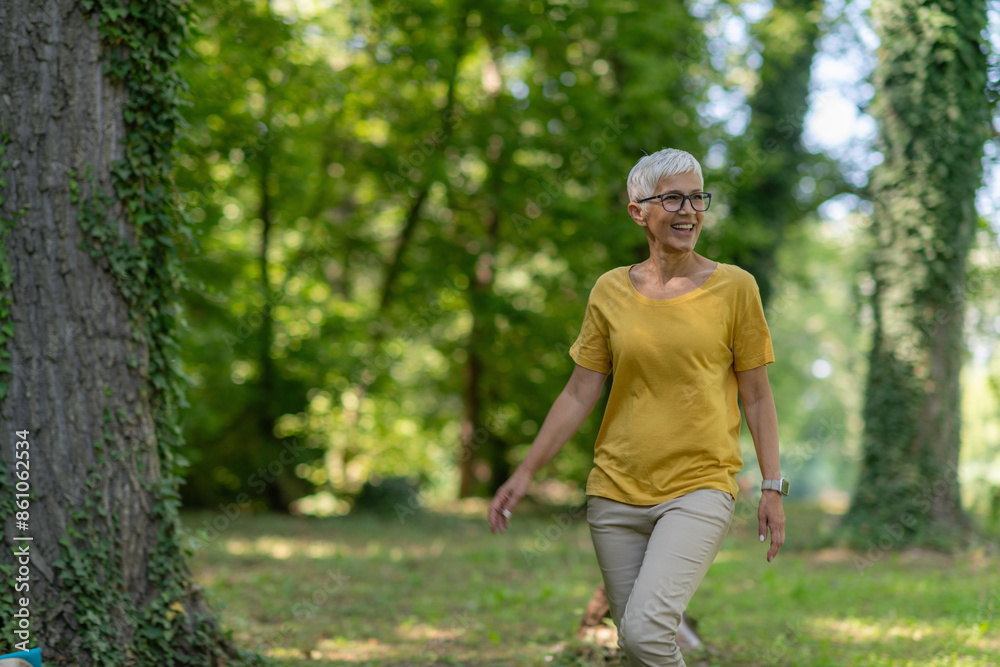 Senior woman enjoying a leisurely walk in the park for health and relaxation. Senior woman enjoying a leisurely walk in the park for health and relaxation.