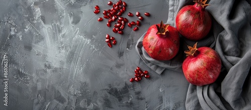 gray textile with pomegranate fruit. with copy space image. Place for adding text or design