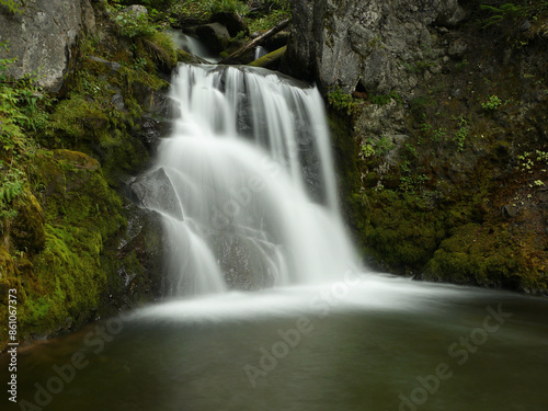 Waterfall in the forest in New Zealand, mysterious scene long exposure time