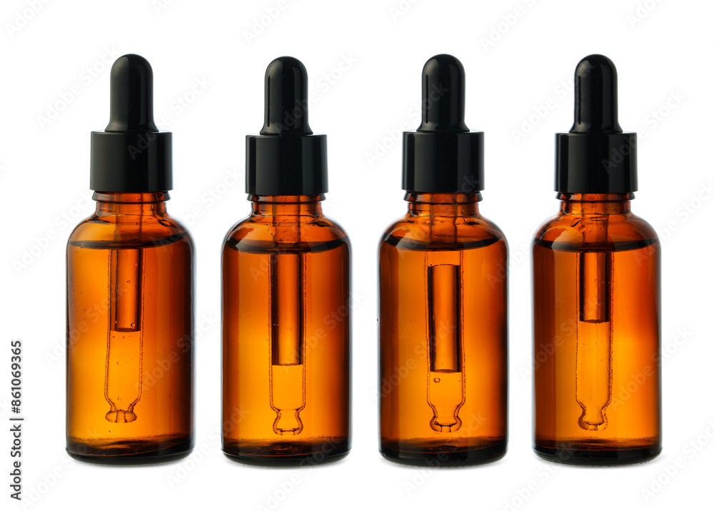 Four Amber Glass Bottles With Black Caps on a White Background Four Amber Glass Bottles With Black Caps on a White Background
