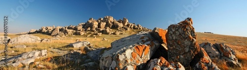 A rocky hillside with a large rock in the foreground