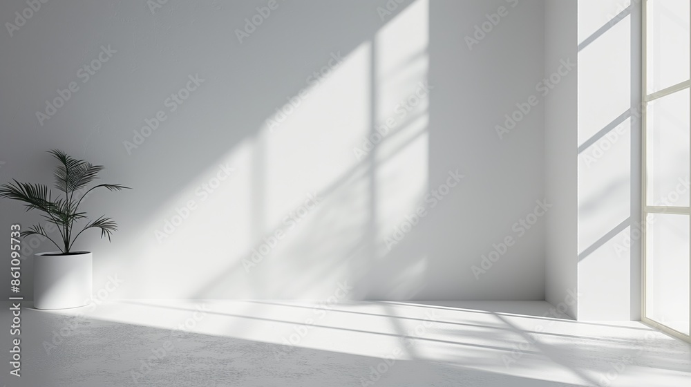 Obraz premium A bright, modern room with a large window casting sunlight beams on the white walls and floor