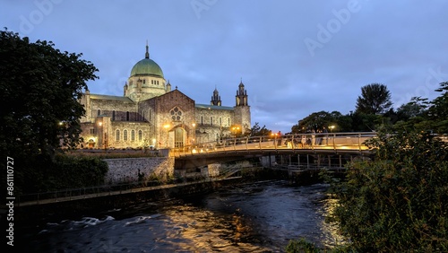 Obraz na płótnie Galway cathedral by night, Salmon Weir Pedestrian bridge over Corrib river, Ireland, historic landmark and architecture w salonie