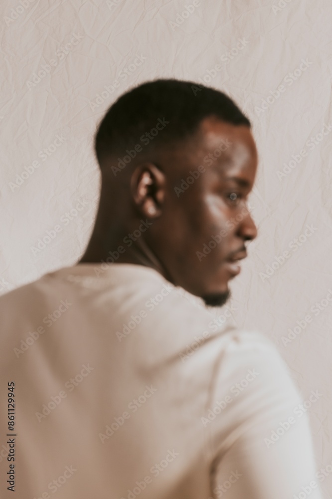 Black man in beige long sleeve, rear view Black man in beige long sleeve, rear view