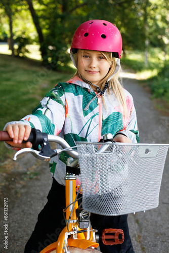 cute young girl on the bicycle in the park