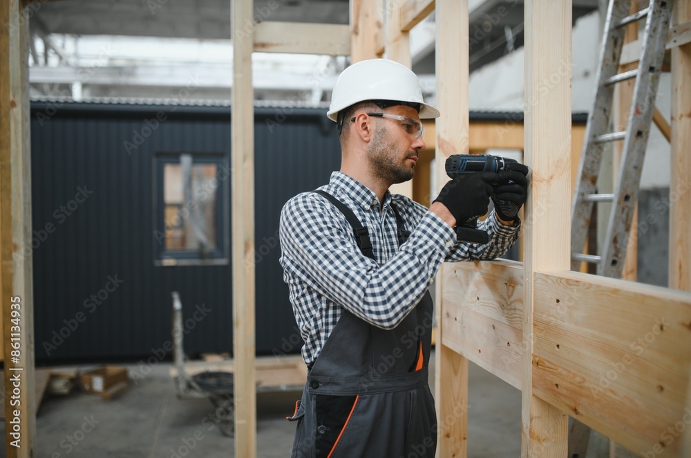 Process of construction new and modern modular house. Worker man in special protective uniform wear working on building development industry of energy efficient property Process of construction new and modern modular house. Worker man in special protective uniform wear working on building development industry of energy efficient property