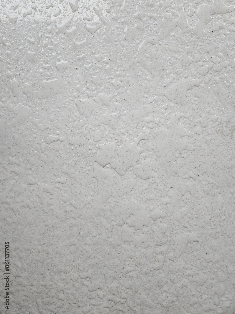 The pattern of water drop on white ceramic tile floor The pattern of water drop on white ceramic tile floor