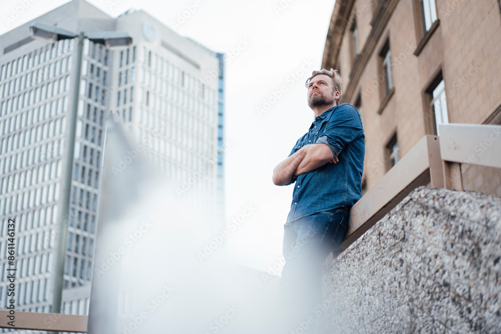 Businessman with arms crossed in front of building Businessman with arms crossed in front of building