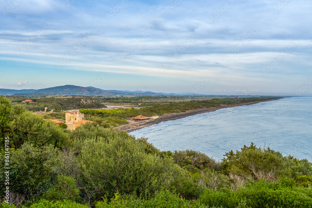 Argentario sea near trees under cloudy sky at Maremma, Tuscany, Italy Argentario sea near trees under cloudy sky at Maremma, Tuscany, Italy