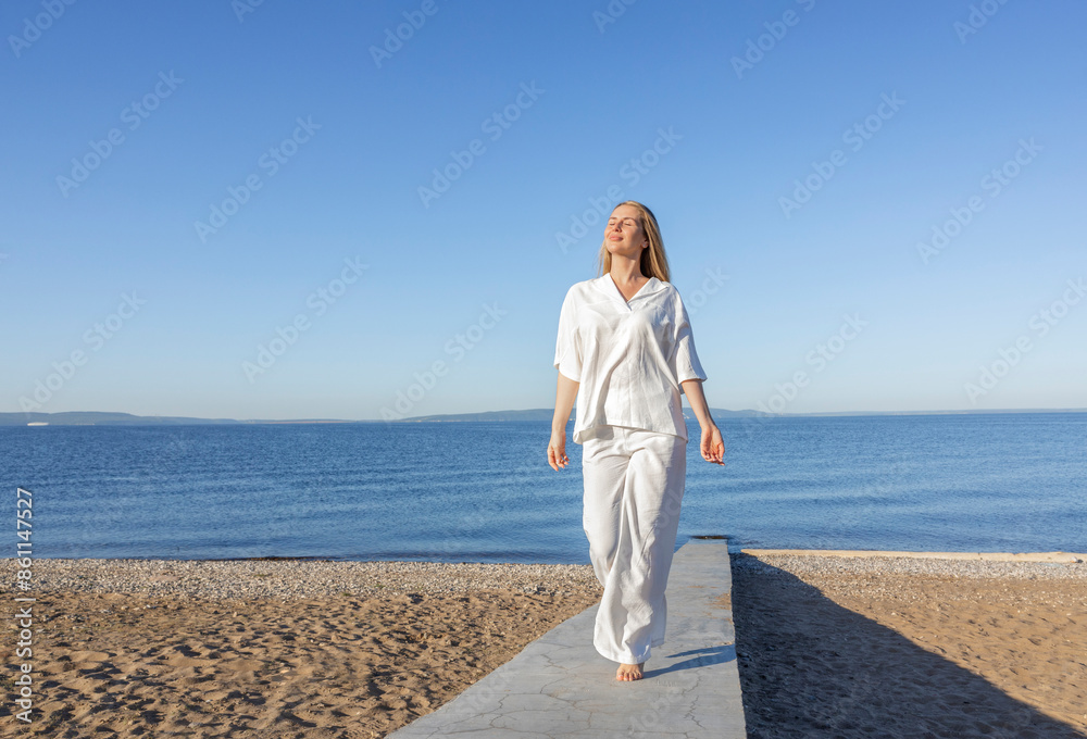Carefree woman and walking on concrete footpath at beach Carefree woman and walking on concrete footpath at beach