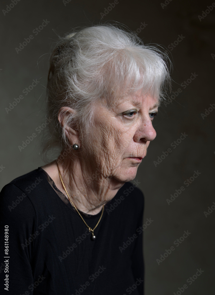 Senior woman with white hair against black background Senior woman with white hair against black background