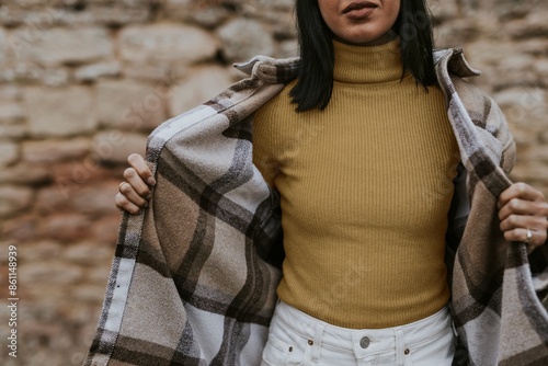 Fotografija Woman putting on flannel jacket, autumn apparel fashion design
