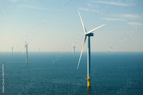 Offshore wind turbines under blue sky in North sea 