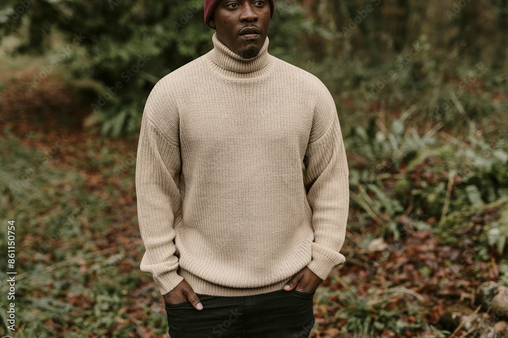 Man in beige turtleneck sweater walking in forest Man in beige turtleneck sweater walking in forest