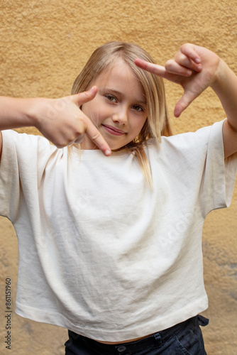 young pretty girl making frame with hands