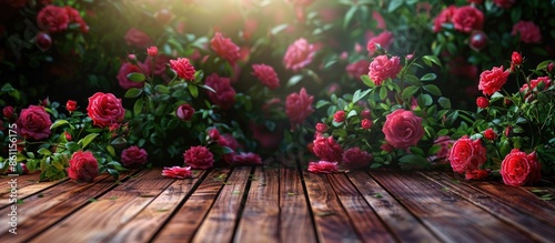 roses bush with wooden floor background. Copy space image. Place for adding text and design © Ilgun