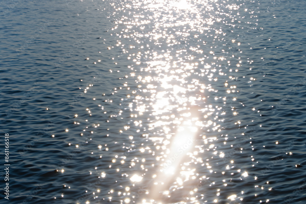 The sun glares through the water in blue. Ocean sea surface concept. A wavy blue water with glare of the sun. The sun wavy with glare of blue and the lifestyle water. The sun glares through the water in blue. Ocean sea surface concept. A wavy blue water with glare of the sun. The sun wavy with glare of blue and the lifestyle water.