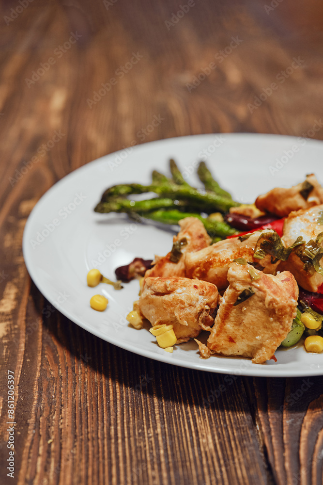 Close-up view of spicy chicken ragout with vegetables and fried asparagus Close-up view of spicy chicken ragout with vegetables and fried asparagus