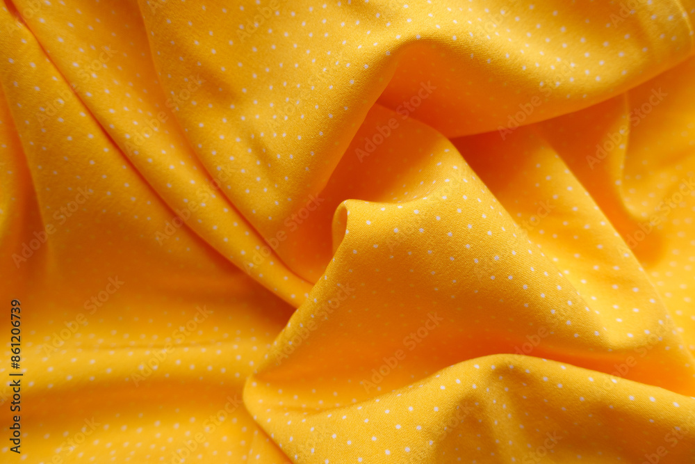 Draped yellow viscose fabric with white pin dot pattern
