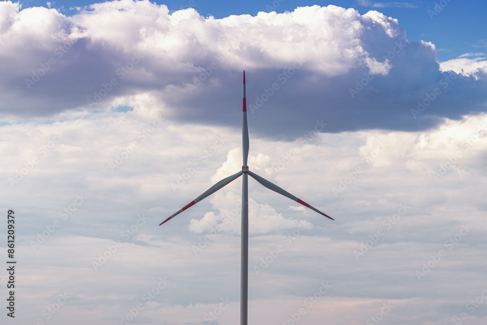 Symmetrical shot of wind turbine against dramatic sky, clean energy Symmetrical shot of wind turbine against dramatic sky, clean energy