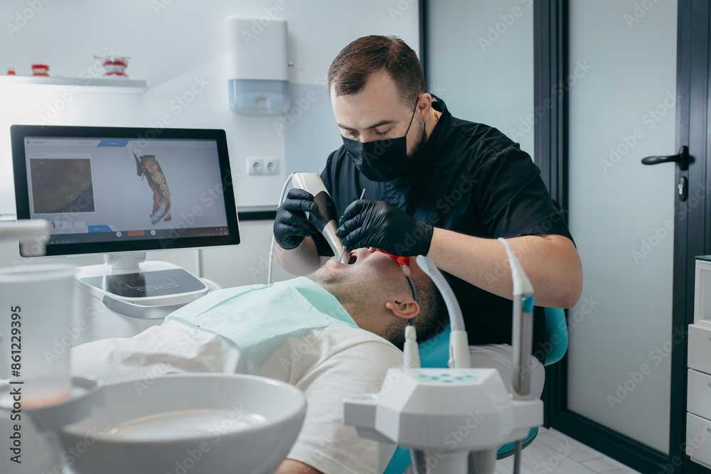 Dentist scanning teeth of male patient with modern scanning 3d machine Dentist scanning teeth of male patient with modern scanning 3d machine