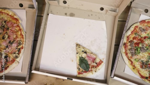 Top view of delivering a pizza box. Pizza slices disappear. Stop motion animation.