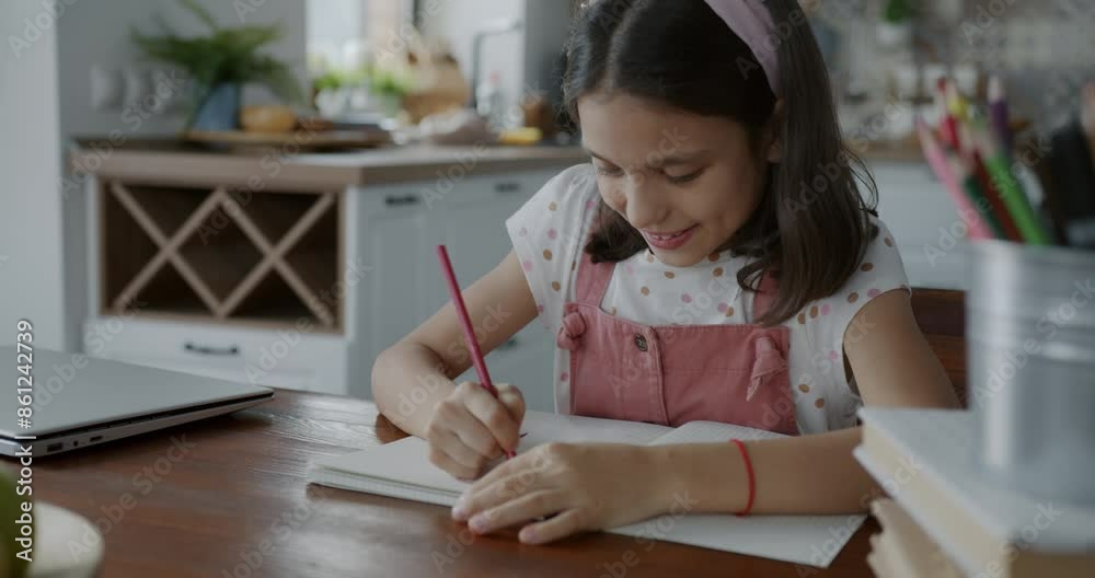 Cute little girl drawing picture with colored pencils focused on creative activity in leisure time at home. Happy childhood and imagination concept. Cute little girl drawing picture with colored pencils focused on creative activity in leisure time at home. Happy childhood and imagination concept.