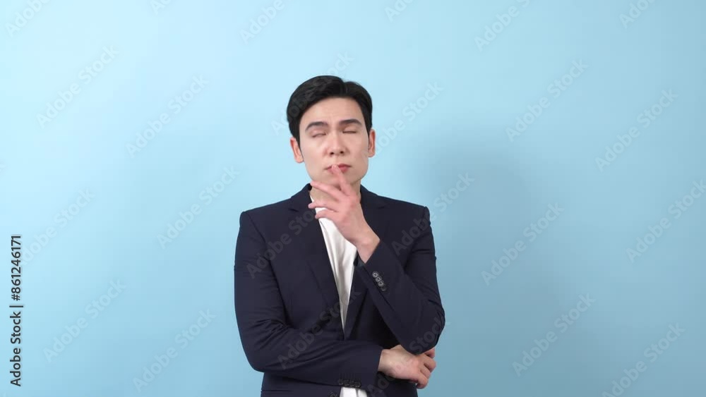 Young Asian businessman on blue background Young Asian businessman on blue background