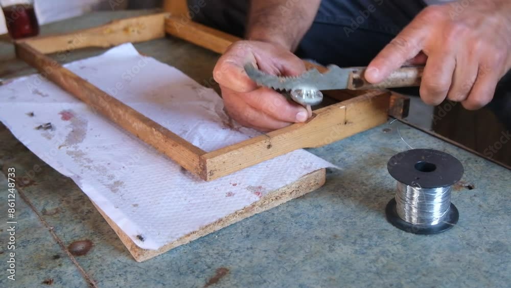 A beekeeper making a honey bar with beeswax. A beekeeper making a honey bar with beeswax.