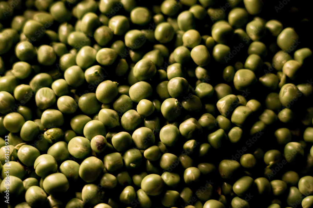 Green peas in a plate on a black background