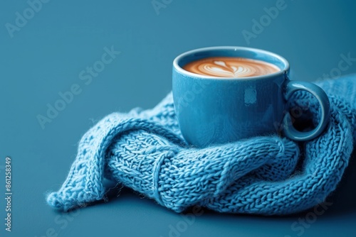 Blue cup with scarfcoffee on blue background. Blue monday concept photo