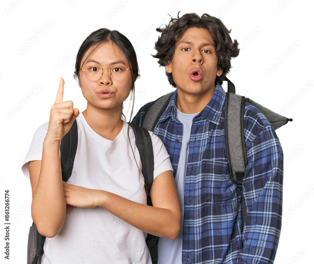 Young interracial student couple studying having some great idea, concept of creativity. Young interracial student couple studying having some great idea, concept of creativity.