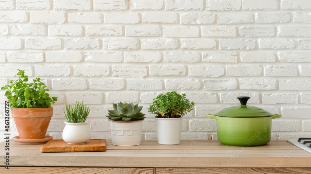 A white kitchen countertop with a white brick wall backdrop, featuring succulents in white pots, white kitchenware, and wooden cutting boards A white kitchen countertop with a white brick wall backdrop, featuring succulents in white pots, white kitchenware, and wooden cutting boards