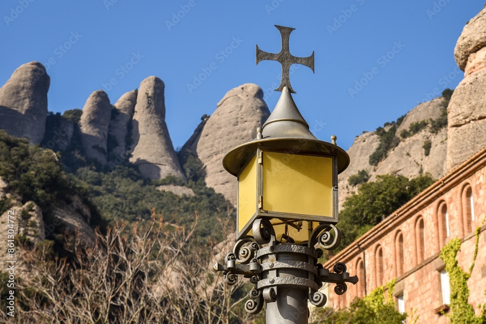cross on the top of a street lamp at the monastery of montserrat in Spain