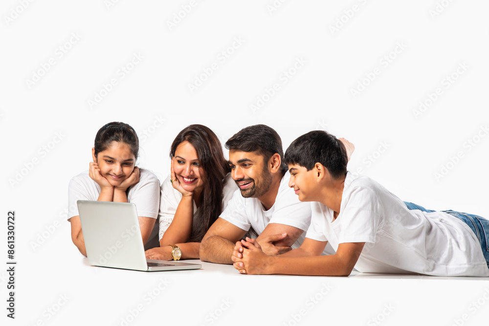 Indian asian young family with parents and kids using computer while sitting isolated on white Indian asian young family with parents and kids using computer while sitting isolated on white